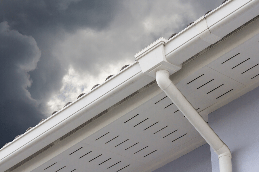 A downspout pictured during an approaching rainstorm.